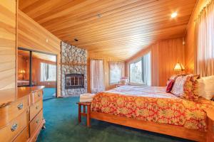 1 dormitorio con 1 cama y chimenea de piedra en Timberline Lodge by AvantStay Secluded Hill Top Home w Incredible Views, en Big Bear Lake