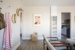 a living room with white walls and a table at Seashore VI by AvantStay Cozy La Jolla Flat 5mins from the Beach in San Diego