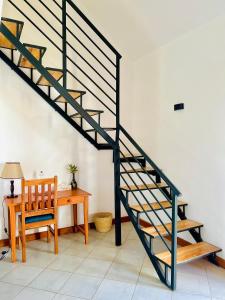 a staircase in a room with a table and a chair at Heart of Africa Lodge in Arusha