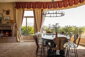 a dining room with a table and chairs and a fireplace at Sangiovese By AvantStay Spectacular Estate w Pool Hot Tub Putting Green in Temecula