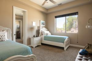 a bedroom with two beds and a window at Sangiovese By AvantStay Spectacular Estate w Pool Hot Tub Putting Green in Temecula