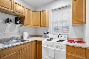 a kitchen with a white stove and a sink at Cozy Studio Apt Near Rittenhouse Square in Philadelphia