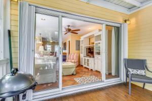 a sliding glass door in a room with a bedroom at Cottage by the Pool by AvantStay w Balcony BBQ Shared Pool Month Long Stays Only in Stock Island