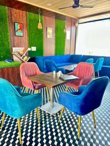 a restaurant with blue chairs and a wooden table at Nahargarh Palace Hotel in Jaipur