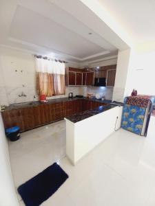 a kitchen with a counter top in a room at Paradise Homes in Agra