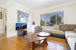 a living room with a couch and a coffee table at Bradman House CBD Launceston Invermay + Free WIFI in Launceston
