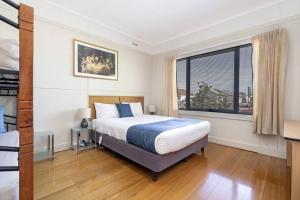 a bedroom with a bed and a large window at Bradman House CBD Launceston Invermay + Free WIFI in Launceston