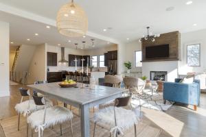 a dining room and living room with a table and chairs at Springsteen by AvantStay Stylish Townhouse in Nashville in Nashville