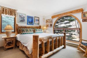 a bedroom with a bed and a large window at Riverside Condos B101 by AvantStay Condo Close To Downtown Town Park Ski Lift 8 in Telluride