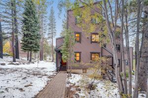 a house in the woods with snow on the ground at Arroyo by AvantStay Peaceful Mountain Townhouse w Large Private Balcony in Kingswood Estates