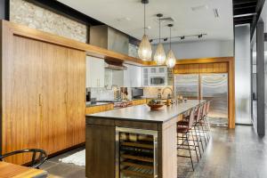 a kitchen with a large island with a counter at Paramount Place by AvantStay 4 Story Apartment in Heart of Austin w Movie Theatre in Austin