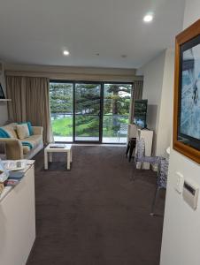 a living room with a couch and a table at The Heart of Glenelg in Glenelg