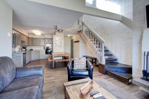 a living room with a couch and a staircase at Silvertown by AvantStay Gorgeous Home in Fantastic Location in Park City in Park City