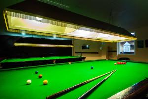 a green pool table with balls on it at Arden Hotel And Leisure Club in Bickenhill