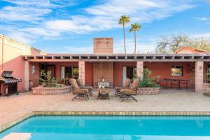 a house with a swimming pool and a patio at La Casona by AvantStay Gorgeous Spanish Style Oasis w Historic Charm Pool in Phoenix
