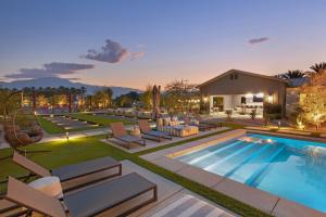 a pool with lounge chairs and a house at Mesquite38 by AvantStay Incredible Estate w Pool, Bar, Tennis & Golf in Sandy Korner
