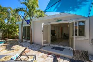 a house with a porch and a patio at Flaglers Oasis by AvantStay Private Pool in Key West Month Long Stays Only in Key West