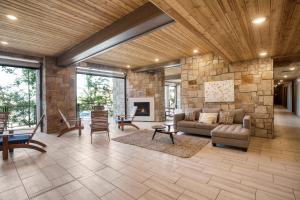 a living room with a couch and a stone wall at Chicane by AvantStay Close to the Ski Slopes in this Majestic Home in Park City in Park City