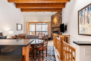 a dining room and living room with a table and chairs at Riverside Condos C202 by AvantStay Condo Close To Downtown Town Park Ski Lift 8 in Telluride