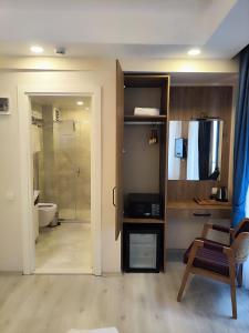 a room with a bathroom with a shower and a toilet at Hotel Esve Istanbul in Istanbul