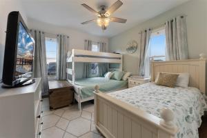 a bedroom with a bed and a flat screen tv at 217 W Maple Ave in Wildwood