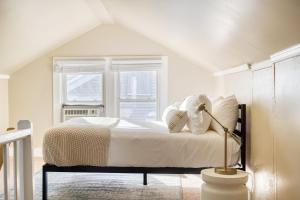 a bedroom with a bed with white sheets and a window at Louise by AvantStay Cute Nashville Home w Large Yard Firepit in Nashville