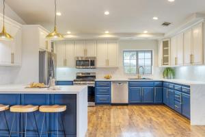 a kitchen with blue cabinets and white counters at Le Grand Bleu by AvantStay Luxury Hilltop Estate in Temecula