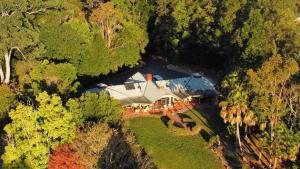 an aerial view of a house in the forest at Evermoore Homestead in Gleniffer