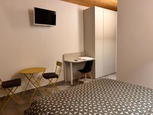 a bedroom with a bed and a table and chairs at Al Borgo camere e colazione in Quero