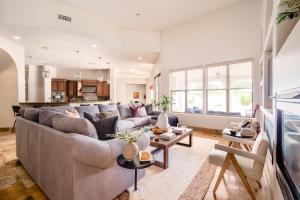 a living room with a couch and a table at Farrier by AvantStay Spectacular 7BR Mediterranean-style Estate w Pool in Scottsdale