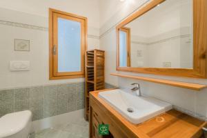 a bathroom with a sink and a mirror at Villa Tiziana in Casa Morcone +37 photos