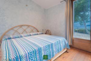 a bedroom with a bed and a large window at Villa Tiziana in Casa Morcone