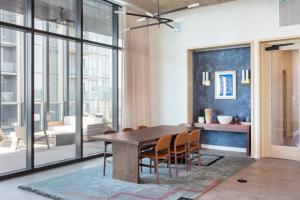 a dining room with a wooden table and chairs at Mohawk by AvantStay Brand New Condo Room in Austin w Amazing Amenities in Austin