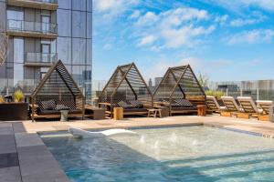 a pool on the roof of a building with lounge chairs at Mohawk by AvantStay Brand New Condo Room in Austin w Amazing Amenities in Austin
