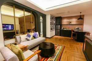 a living room with a couch and a kitchen at Java Paragon Hotel & Residences in Surabaya