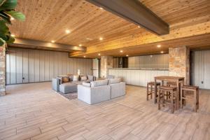 a living room with a couch and a table at Kestrel by AvantStay Close to the Ski Slopes in this Majestic Home in Park City in Park City