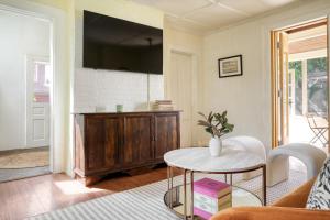 a living room with a table and a tv at Eloise by AvantStay Historic Upstate Apartment near Hudson River in Saugerties