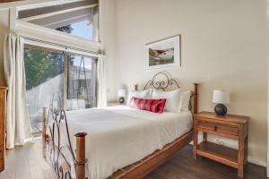 a bedroom with a large bed and a window at Marillac by AvantStay Gorgeous Ski Cabin w Balcony Patio in Olympic Valley