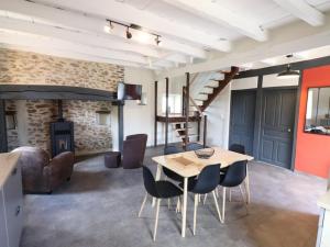 a dining room with a table and chairs and a fireplace at Gîte Maurs, 3 pièces, 5 personnes - FR-1-742-135 in Maurs