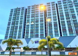 um grande edifício com palmeiras em frente em MV Suite Homestay em Kuantan