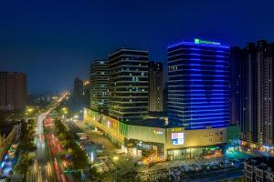 a city lit up at night with buildings at Holiday Inn Express Heze City Center, an IHG Hotel in Heze