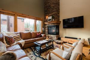 uma sala de estar com sofás e uma lareira em Camber by AvantStay Cozy Chic Cabin w Hot Tub em Breckenridge