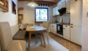 uma pequena cozinha com uma mesa e uma sala de jantar em Gästehaus Sissy em Längenfeld