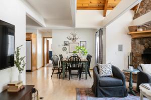 a dining room and living room with a table and chairs at Hartwood by AvantStay Cozy Big Bear Abode w Spacious Deck Stone Fireplace in Big Bear Lake