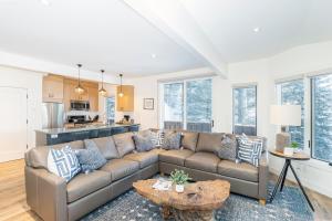a living room with a couch and a table at Manitou Riverhouse 115 by AvantStay Spacious Condo in the Centre of Telluride in Telluride