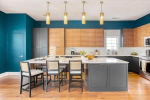 a kitchen with a large table with chairs and blue walls at Ramsey by AvantStay Modern Character Home in Austin w Pool in Austin