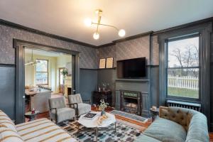 a living room with a couch and a fireplace at Elliot by AvantStay Historic Character Home in Great Location in Saugerties