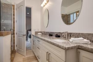 a bathroom with a sink and a mirror at Malbec by AvantStay Incredible Estate w Panoramic Views Bocce Ball Court in Sage