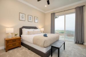 a bedroom with a large bed and a window at Malbec by AvantStay Incredible Estate w Panoramic Views Bocce Ball Court in Sage