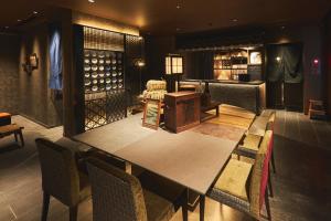 a dining room with a table and chairs at SAKE Kura Hotel 川崎宿 in Kawasaki